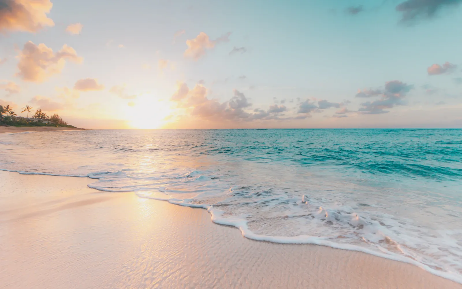A peaceful stretch of white sand and turquoise ocean
