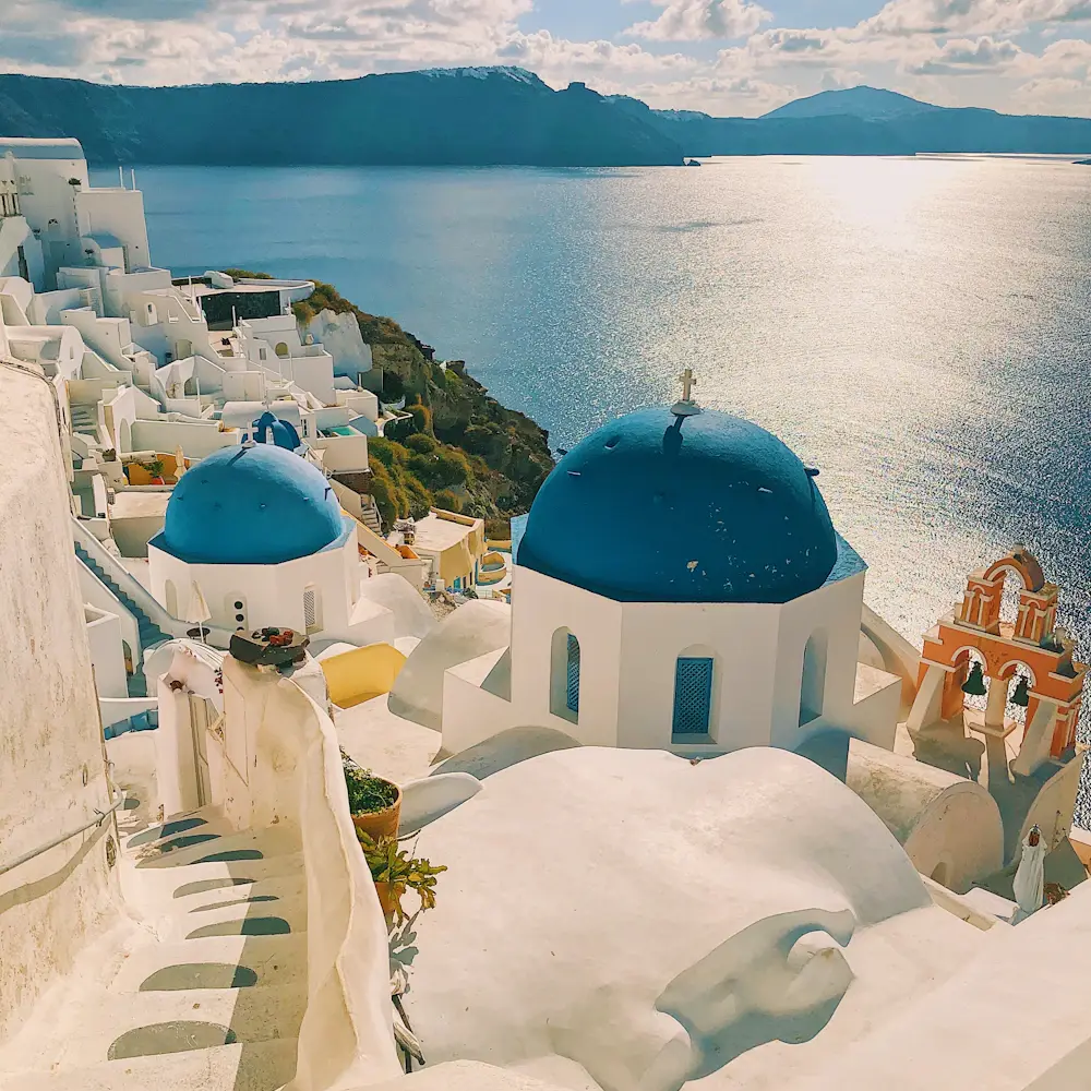 Whitewashed Santorini buildings and blue domes overlooking the Aegean Sea
